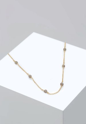 Gold chain necklace featuring round, textured beads. Simple design with alternating bead placements and a smooth, even finish.