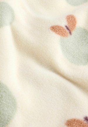 Fleece deken in crème met grote mintgroene cirkels en motief van vlinders in bruin en paars. Zachte textuur en warme uitstraling.