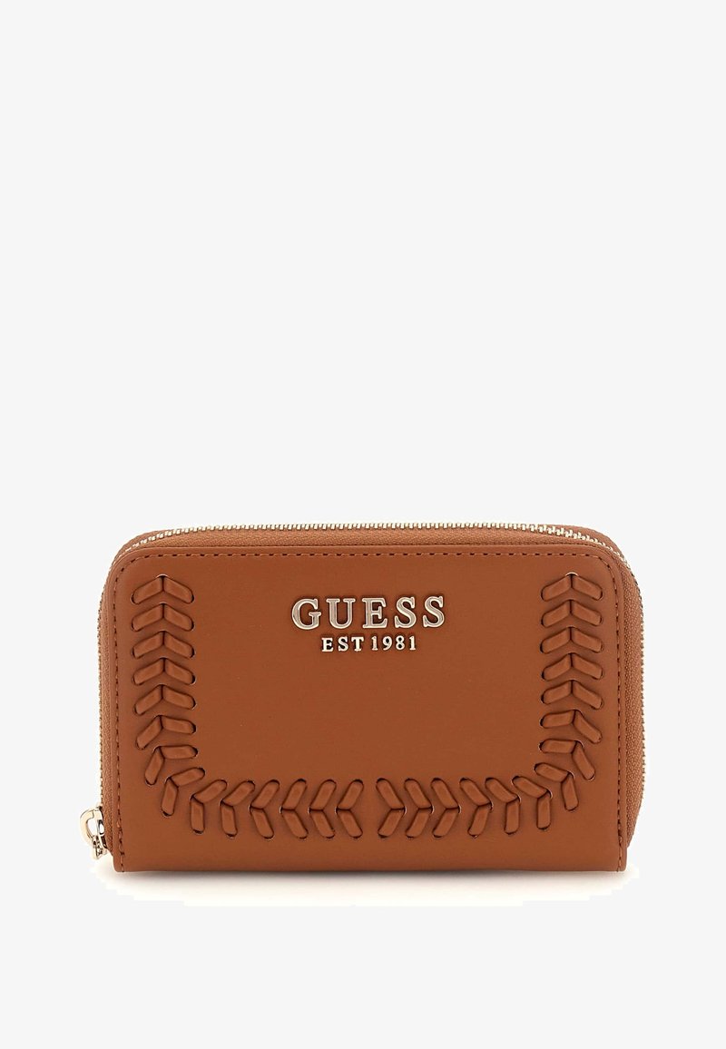 Brown faux leather wallet with embossed stitching patterns, silver logo "GUESS EST 1981" at the front, and a zip-around closure.