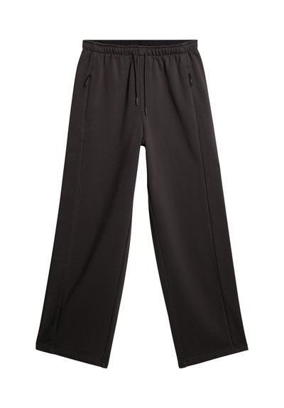Pantalons noirs à jambes larges en tissu doux. Dotés d'une taille élastique avec cordon de serrage et de poches latérales. Texture lisse avec coutures droites.