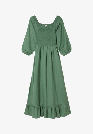 Green cotton dress with a square neckline, smocked bodice, puff sleeves, and a ruffled hem. The fabric has a textured weave.