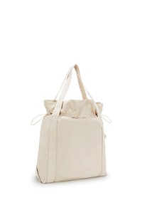 Beige nylon tote bag med två långa handtag, dragsko-stängning och stor huvudfack. Slät struktur, minimalistisk design.