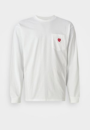 White long-sleeve T-shirt made of cotton, featuring a left chest pocket with a red heart patch. Classic crew neck and ribbed cuffs.