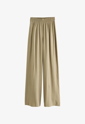 Bež hlače širokega kroja z elastiko v pasu in stranskimi žepi, narejene iz gladkega lahkega materiala.