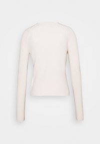 Langärmliges Oberteil aus weichem, hellbeigem Stoff. Figurbetontes Design mit rundem Ausschnitt und gerippter Textur. Keine sichtbaren Logos oder Muster.