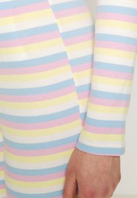 Camisola de mangas longas em ribana com listras horizontais em rosa, azul, amarelo e branco. Tecido macio com um design ajustado e mangas com punhos.