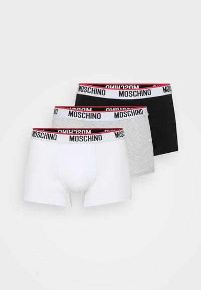 Three pairs of Moschino boxer briefs in white, gray, and black. Each has a branded waistband featuring white, red, and black colors.