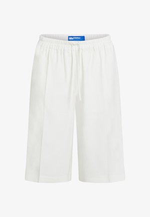 Valged põlveni ulatuvad lühikesed püksid elastse vöörihma ja nööriga, millel on nähtav sinine Karl Lagerfeld Jeansi silt sees.