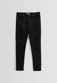 Svarta skinny jeans med slitna detaljer, med revor på låren och knäna, tillverkade av denim med en mjuk textur.