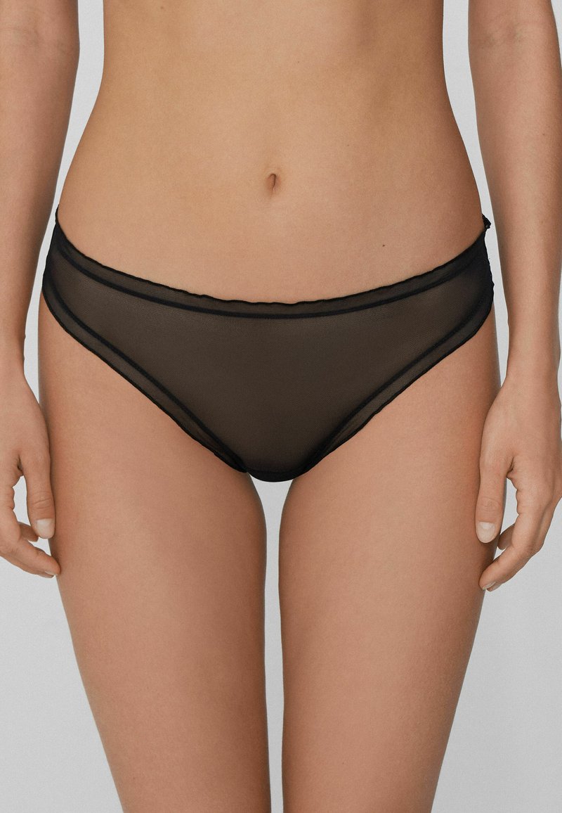 Culotte de bikini en maille noire à texture lisse, dotée d'une large ceinture et de bords festonnés, conçue pour une coupe élégante.