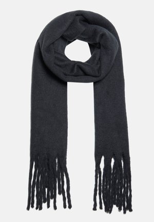 Écharpe en laine gris foncé avec de longs franges aux deux extrémités, pliée en boucle sur un fond clair uni.