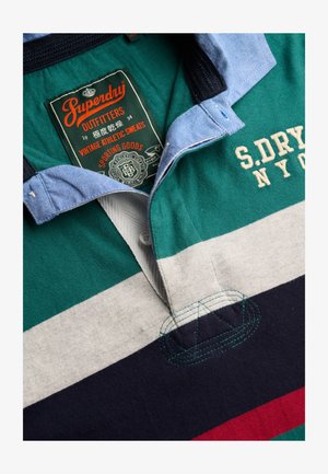 Collared rugby shirt with green, white, navy, and red stripes, blue collar, and embroidered "S.DRY NYC" text on the chest.