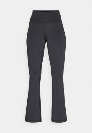 Sorte højtaljede flare leggins med synlige syninger, lavet af strækbart, glat stof, vist fladt mod en hvid baggrund.