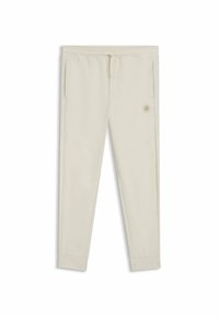 Helle beige Jogginghose aus weichem Material mit elastischem Bund, seitlichen Taschen und einem kleinen Logo-Aufnäher auf der Vorderseite.