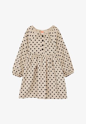 Beige kjole med sorte prikker, rund halsudskæring, lange ærmer og en samlet talje, med en knaplukning foran. Blødt stof.