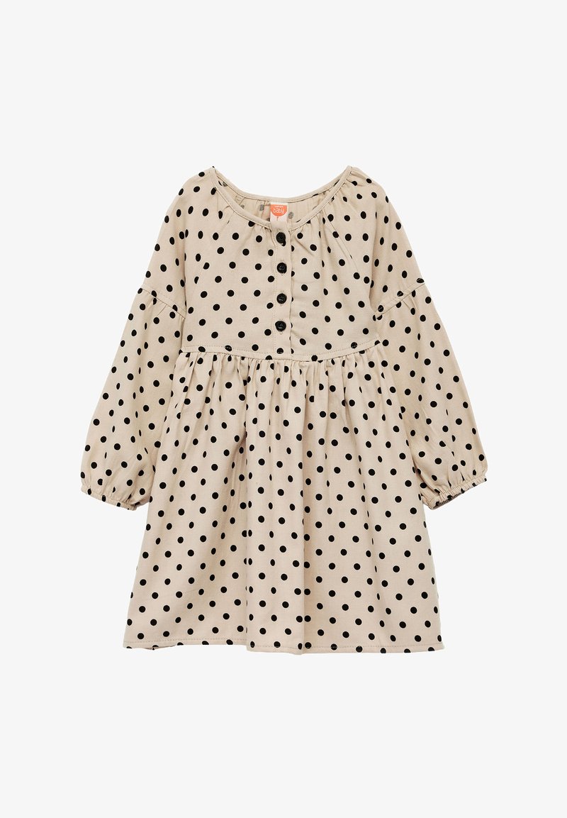 Robe beige à pois noirs, encolure ronde, manches longues et taille froncée, avec une fermeture à boutons sur le devant. Texture de tissu douce.