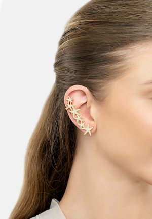 Gold ear cuff featuring five starfish shapes with a textured surface, designed to fit along the edge of the ear.