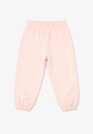 Jasnoróżowe spodnie dresowe z elastycznym pasem i ściągaczami oraz słabym pionowym napisem na prawej nogawce, ułożone płasko na białym tle.