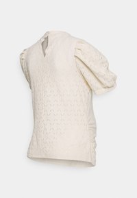 Kremowa bluzka z krótkim rękawem wykonana z teksturowanego dzianinowego materiału, z bufkami na rękawach oraz dekoltem w kształcie litery V, zapinana z tyłu na guziki.