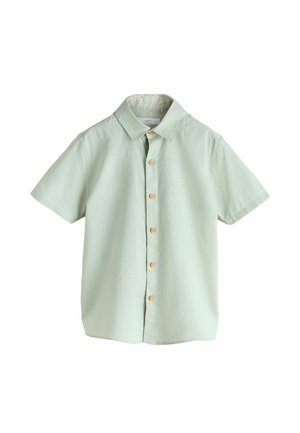 Helerohelise tooniga lühikeste varrukatega särginuppude ja kraega, millel on puidust nupud, valge tausta vastu eksponeeritud.