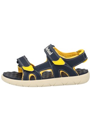 Sandale ajustable pour enfants bleu marine et jaune avec semelle rembourrée et bandes Velcro pour le maintien du talon et de la cheville.