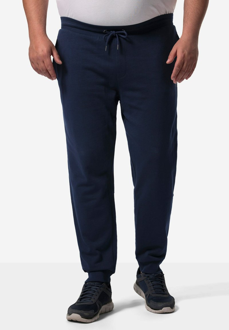 Marineblaue Jogginghosen aus weichem Stoff, mit einem elastischen Bund mit Kordelzug, seitlichen Taschen und schmal zulaufenden Bündchen.