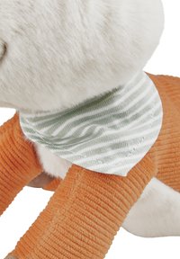 Stuffed animal with white fur, orange corduroy limbs, and a striped green and white fabric scarf around its neck.