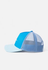 Blue cap with a soft front panel and mesh back, featuring a flat brim and a contrasting light blue visor. Displays simple logo detail.