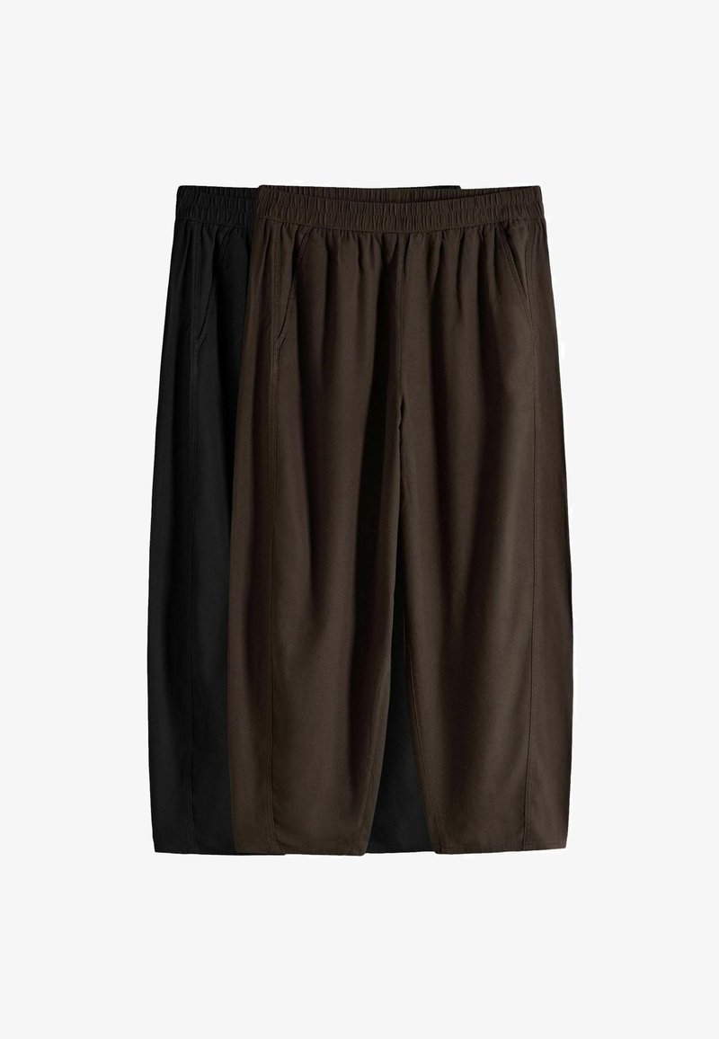 Deux pantalons amples, l'un marron foncé à l'avant et l'autre noir à l'arrière, tous deux avec des bandes élastiques à la taille et des poches latérales.