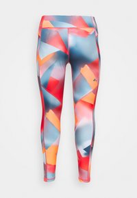 Leggings de sport colorés arborant un motif géométrique avec des formes rouges, bleues et oranges. Fabriqués à partir d'un tissu extensible avec une texture lisse.