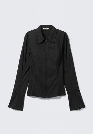 Black long-sleeve fitted jacket with front zipper, flared cuffs, and pointed collar, laid flat on a light background.