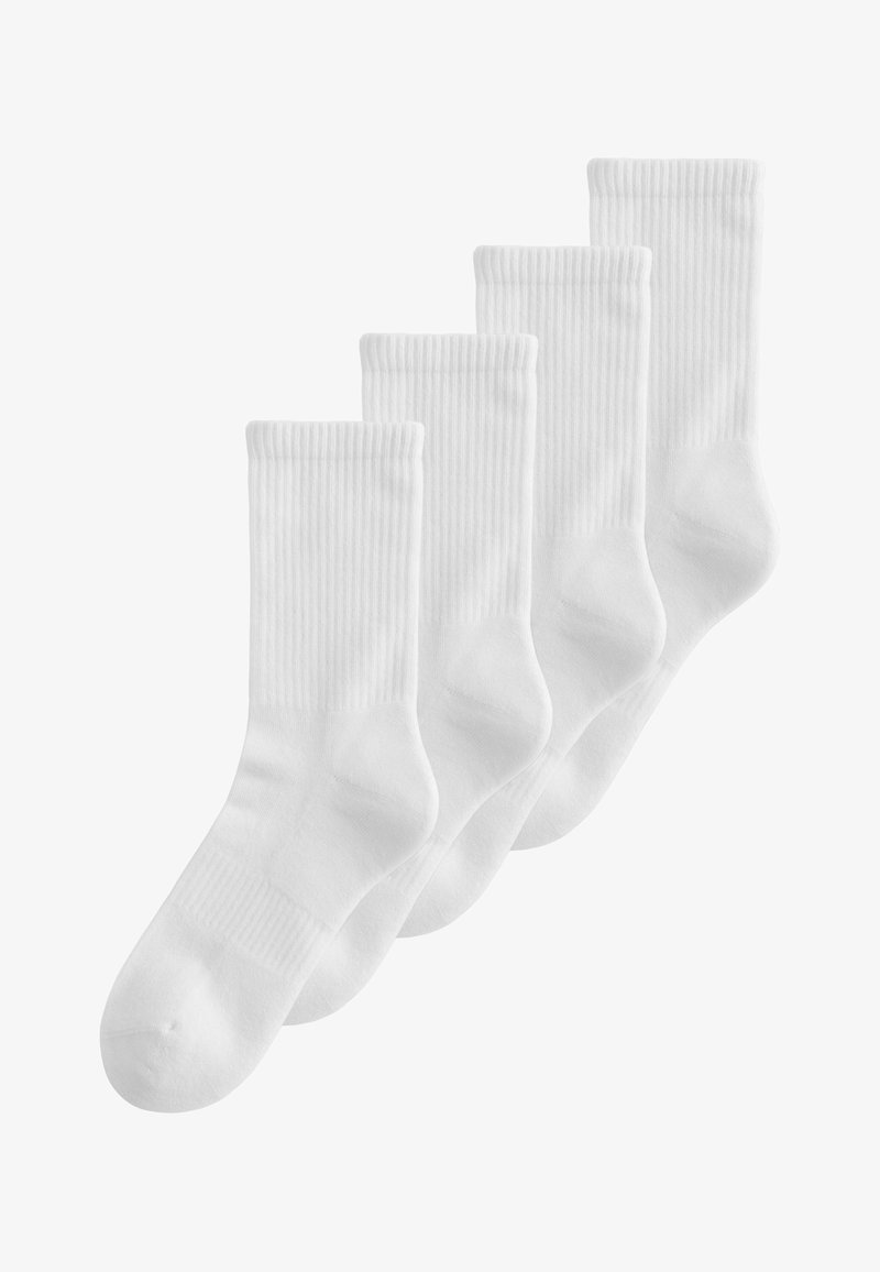 Quatre paires de chaussettes blanches unies mi-mollet, texture côtelée, disposées en rang sur un fond blanc.