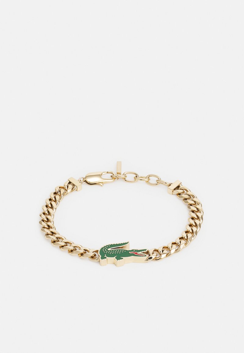 Goldene Kettenarmband mit charmantem Krokodil in Grün und Rot. Die Glieder sind dick und mit einem sicheren Verschluss ausgestattet. Glatte metallische Textur.
