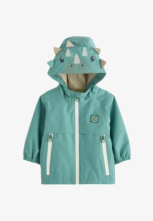Tyrkysová pršiplášť s kapucňou v tvare dinosaura. Má biely zips, elastické manžety a nášivku s logom. Kapucňa má výčnelky a priateľský dizajn tváre.