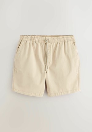 Beige zwemshorts met een elastische tailleband met trekkoord, zijzakken en een gladde, lichte stof.