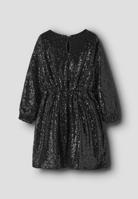 Robe mini à manches longues noire entièrement pailletée, taille élastique, poignets froncés et petite fermeture à bouton dans le dos au niveau du col.