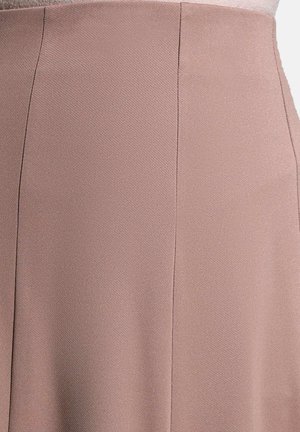 Light pink skirt with a textured, woven fabric. Features a smooth finish and clean lines, emphasizing a tailored shape.