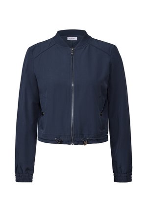 Chaqueta bomber azul marino con cremallera frontal, bolsillos laterales, puños elásticos y dobladillo ajustable con cordón. Acabado de tela suave.