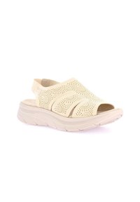 Sandalo beige con design a intaglio, punta aperta e sottile cinturino alla caviglia. Presenta una suola spessa e scanalata per ammortizzazione e supporto.
