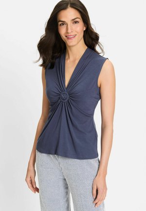 Navy sleeveless top with a deep V-neck and twisted knot detail at the center, made from soft, smooth fabric, paired with striped pants.