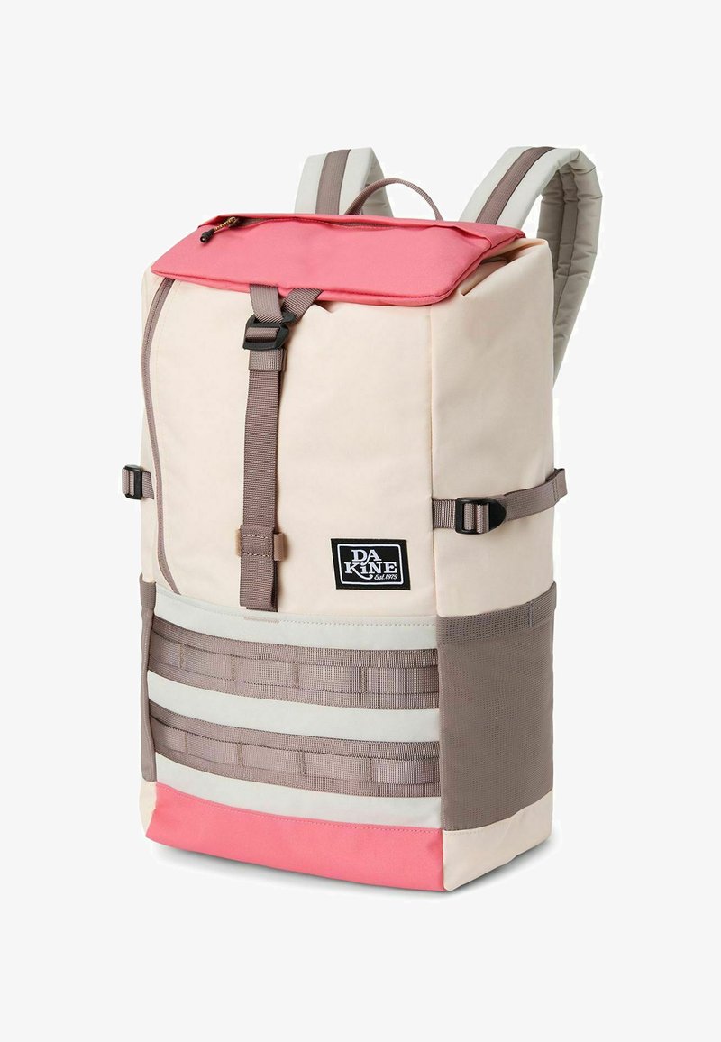 Backpack with a pink top flap, beige body, and horizontal gray straps. Features include a logo patch and adjustable side buckles.