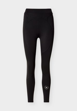 Černé sportovní legíny s vysokým pasem, zakončené zakřivenými švy a kulatým bílým logem na spodní pravé noze.