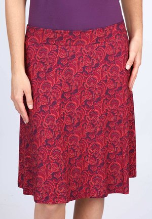 Floral print skirt with a fitted waist in deep burgundy and red colors. Features a swirling floral pattern throughout the fabric.