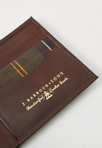 Brown leather cardholder with plaid fabric pocket and gold embossed "J. Barbour & Sons Handcrafted Leather Goods" logo on white background.