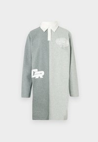 Ilgas rankovėmis polo suknelė dviejų pilkų atspalvių, su balta apykakle ir grafiškais atspaudais. Minkštas medvilnės mišinys, laisvo silueto.