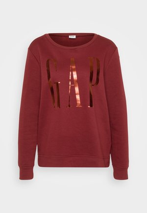 Sweatshirt de cor bordô feito de algodão com decote redondo. Apresenta grande texto refletivo "GAP" em bronze. Mangas longas, punhos e barra canelados.