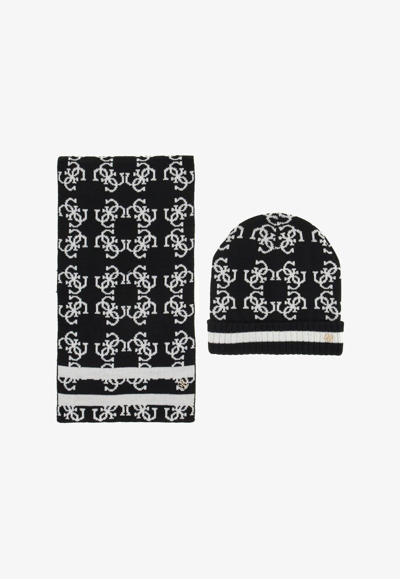 Set di sciarpa e berretto a maglia in bianco e nero con un motivo ripetitivo, caratterizzato da una spessa striscia bianca sulla sciarpa e una cuffia piegata sul berretto.