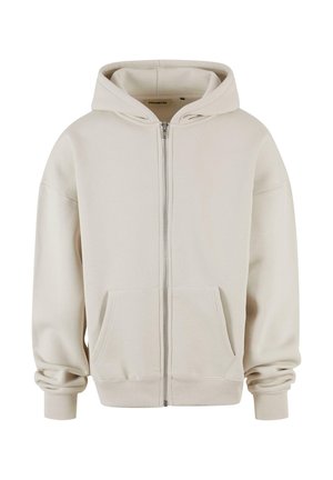 Light beige zip-up hoodie made of soft fabric. Features a kangaroo pocket, ribbed cuffs, and a lined hood. Simple, classic design.