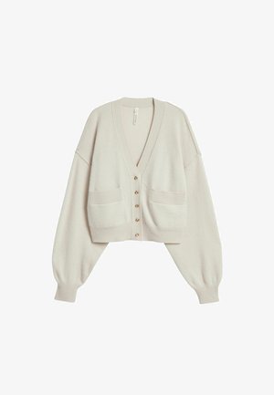 Lichtbeige cropped vest met lange pofmouwen, geribbelde manchetten, twee zakken aan de voorkant en vijf knopen in het midden.