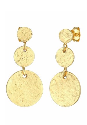 Boucles d'oreilles pendantes ton or avec trois disques circulaires texturés et connectés de taille croissante sur fond blanc.